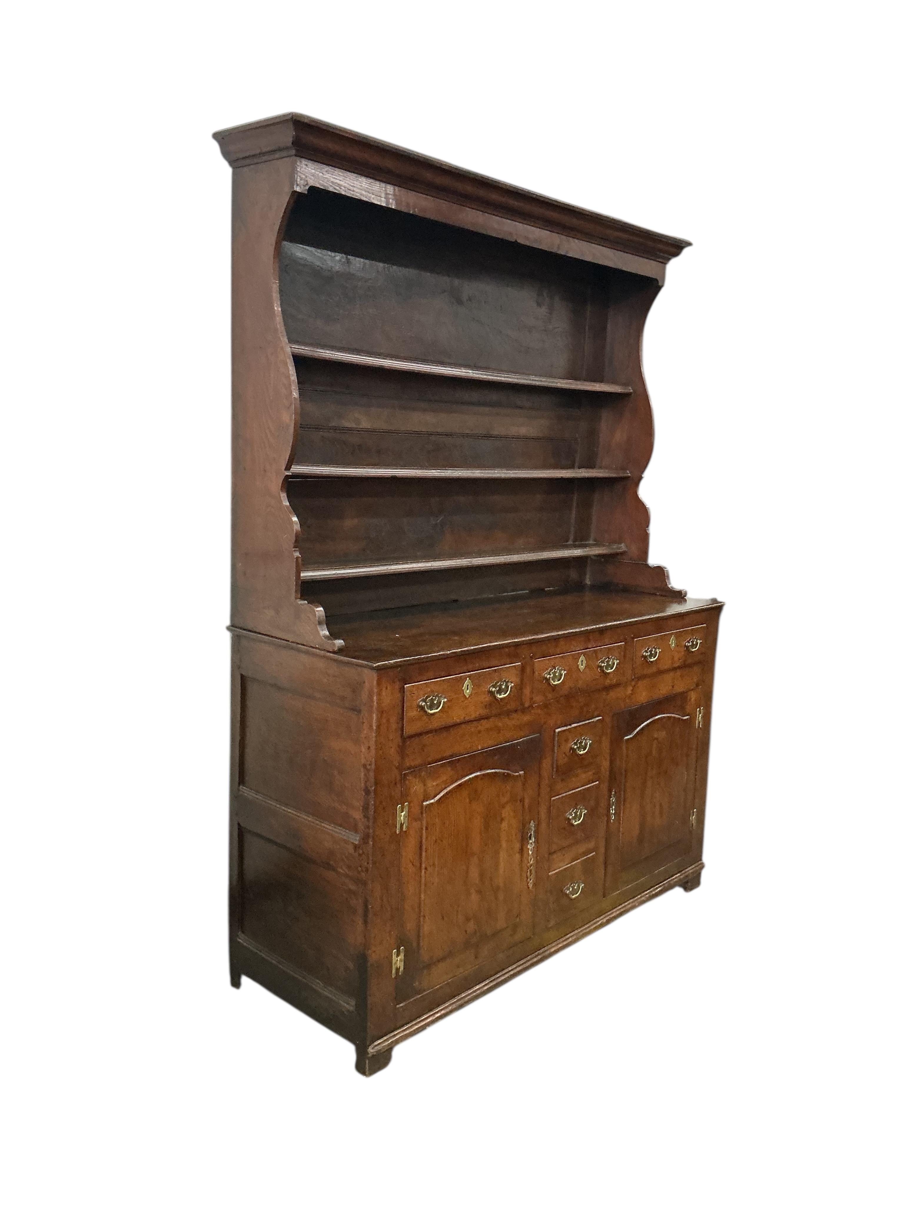 An early 18th century North Wales oak dresser, with boarded rack, width 144cm, depth 52cm, height 196cm